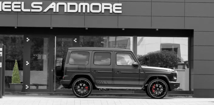 full side view black g63 amg with 24 inch wheels