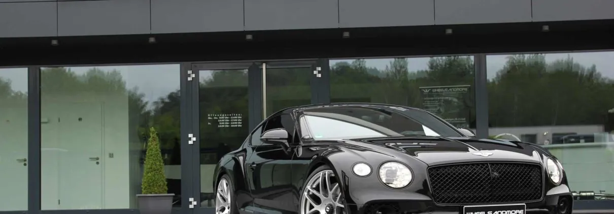 front side view black continental with tuning products from wheelsandmore
