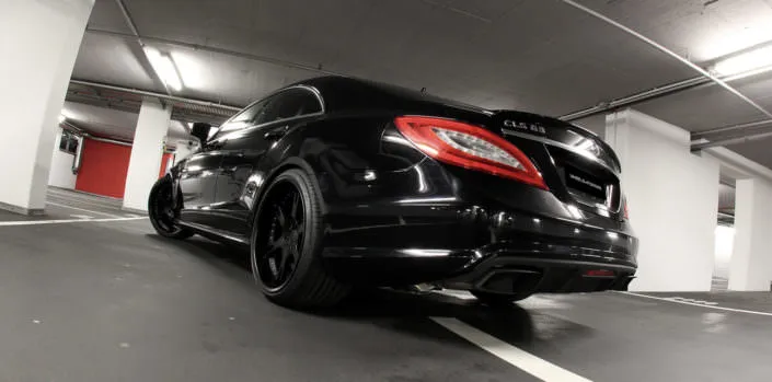 rear side view all over black tuned mercedes cls 63 amg