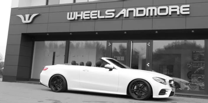 e400 convertible side view white car with 20 inch black fivestar wheels